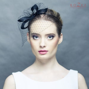 Black fascinator with openwork petals and veiling, black veiling with modern decoration, fascinator with netting