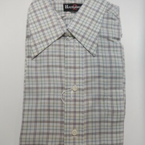 May include: A white, blue, and brown plaid button-down shirt with the brand name "Hathaway" on the collar.