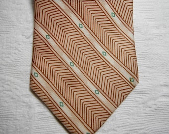 May include: A brown and beige patterned tie with a diagonal stripe design. The pattern includes small green diamonds.