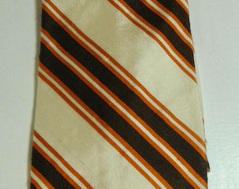 May include: A striped tie with brown and orange stripes on a white background.