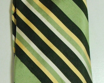 May include: A green, black, and white striped tie. The stripes are diagonal and the tie is made of a silky material.