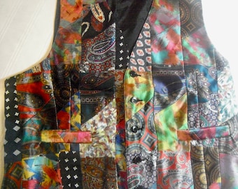 May include: A multi-colored patchwork vest with a paisley pattern. The vest has a black satin lining and three buttons.