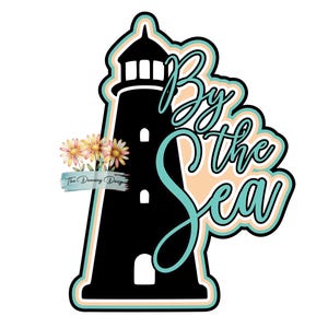 May include: A black lighthouse silhouette graphic with the text By the Sea in teal script. The design features a peach-colored outline, a small cluster of watercolor-style daisies, and the text The Dancing Daisy in a small blue brush stroke.