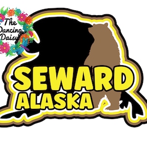 May include: A sticker featuring a brown bear silhouette inside a black shape, with the words "SEWARD ALASKA" in yellow. The design is outlined in yellow and brown, with a floral and dragonfly logo in the upper left corner.