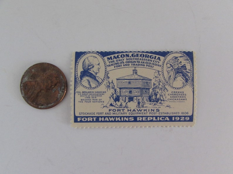 May include: A vintage postcard replica of Fort Hawkins in Macon, Georgia. The postcard features a blue and white illustration of the fort, a portrait of Colonel Benjamin Hawkins, and a portrait of a Native American chief. The text on the postcard reads "Macon, Georgia, The Only Southeastern City Tracing Its Origin to an Old Indian Fort and Trading Post."  "Fort Hawkins, Stockade Fort and Military Equipment Post - Established 1806."  "Fort Hawkins Replica 1929."