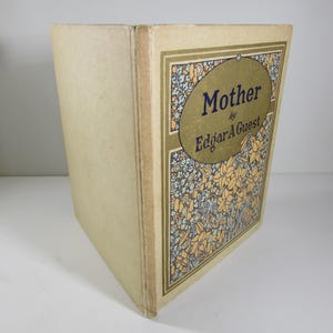 May include: A vintage book titled "Mother" by Edgar A. Guest. The cover features a floral design in shades of blue, yellow, and green.