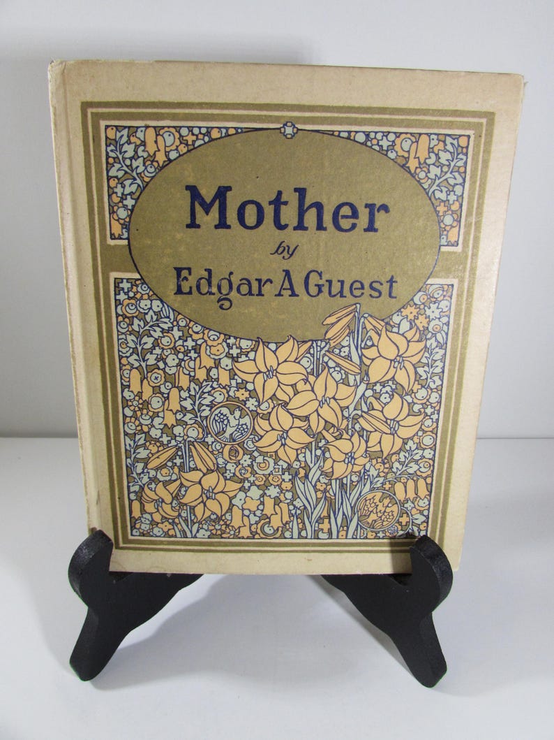 May include: A vintage book titled "Mother" by Edgar A. Guest. The cover features a floral design with yellow flowers and green leaves on a beige background.