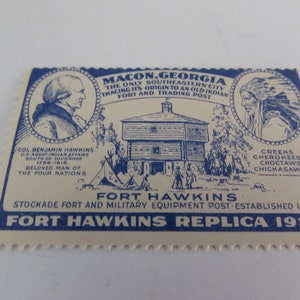 May include: A blue and white vintage postcard depicting Fort Hawkins in Macon, Georgia. The postcard features a drawing of the fort, a portrait of Col. Benjamin Hawkins, and a portrait of a Native American. The text on the postcard reads "Macon, Georgia, The Only Southeastern City Tracing Its Origin To An Old Indian Fort And Trading Post", "Fort Hawkins, Stockade Fort And Military Equipment Post-Established 1806", and "Fort Hawkins Replica 1929".