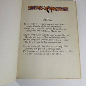 May include: A vintage book with a poem about a mother's love. The poem is printed on cream-colored paper with black text. The book has a brown cover with a decorative floral border and a small illustration of a woman.