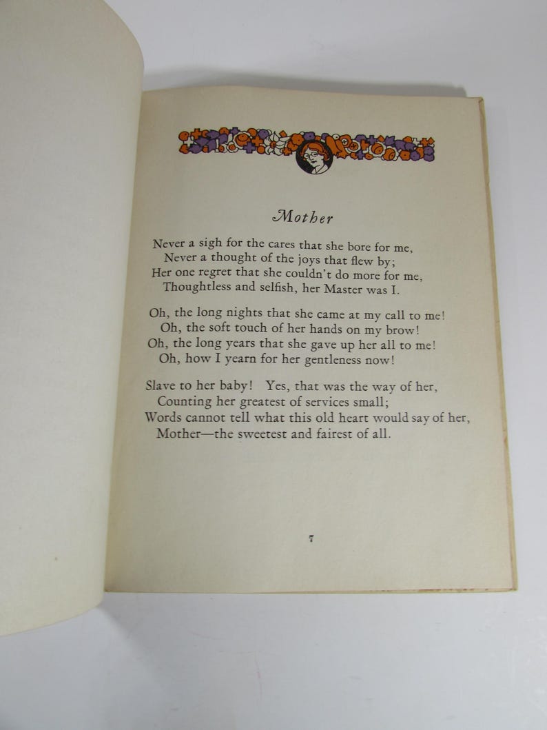 May include: A vintage book with a poem about a mother's love. The poem is printed on cream-colored paper with black text. The book has a brown cover with a decorative floral border and a small illustration of a woman.