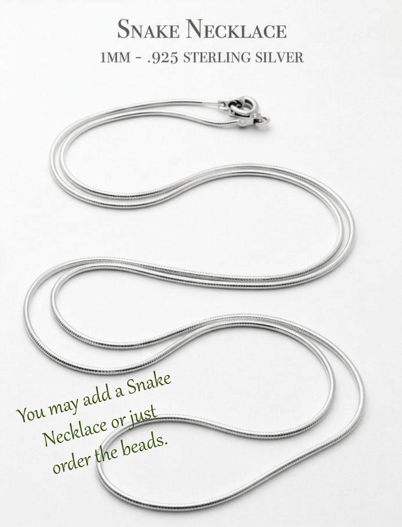 May include: A 1mm .925 sterling silver snake necklace with a lobster claw clasp. The text at the top reads "SNAKE NECKLACE 1MM - .925 STERLING SILVER" and the text at the bottom reads "You may add a Snake Necklace or just order the beads."