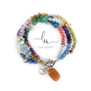Multi-strand bracelet featuring a variety of colorful gemstones, including amethyst, rose quartz, aquamarine, and citrine. The bracelet has a silver clasp and a heart charm.