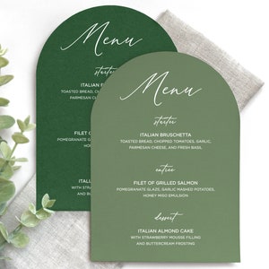 May include: Two arch-shaped menu cards in dark green and sage green with white text. The menus list courses including Italian Bruschetta, Filet of Grilled Salmon, and Italian Almond Cake, featuring headings for starter, entree, and dessert.