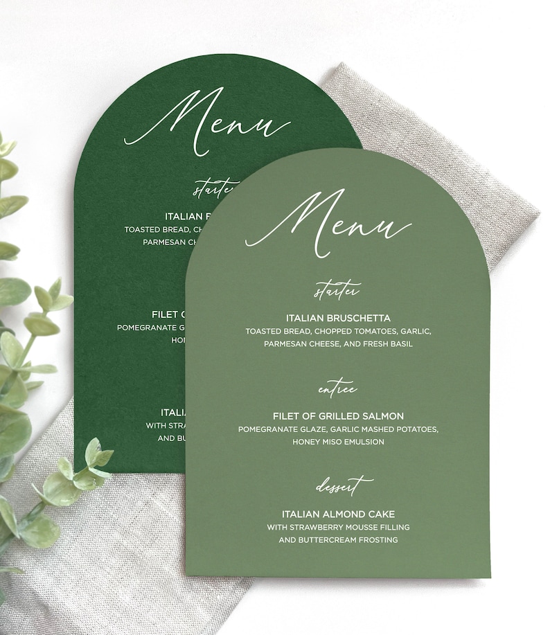 May include: Two arch-shaped menu cards in dark green and sage green with white text. The menus list courses including Italian Bruschetta, Filet of Grilled Salmon, and Italian Almond Cake, featuring headings for starter, entree, and dessert.