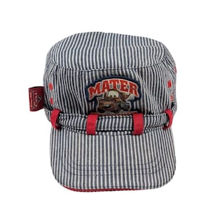 May include: Blue and white striped cap with a red brim and accents. The cap features an embroidered patch with the word "MATER" and a cartoon image of a car. A small tag with the Disney Pixar Cars logo is on the side.
