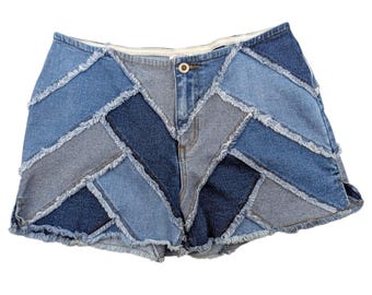 May include: Denim shorts with a patchwork design. The shorts feature a variety of blue denim shades, sewn together in a geometric pattern. The edges of the denim are frayed, and the shorts have a button and zipper closure.