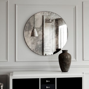 Frameless round antiqued mirror. Light, smoky antiqued finish in classic Modern design. Perfect accent mirror.