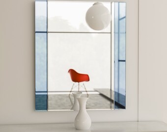Deco style wall mirror with blue mirrored sides and clear mirror center. Unique blue accented wall mirror