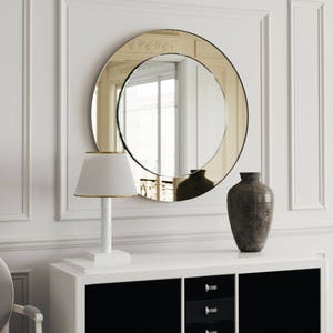 Round gold Mirror. Golden mirror with custom, gold glass mirror and symmetrical design. Hanging wall mirror with rich golden hue