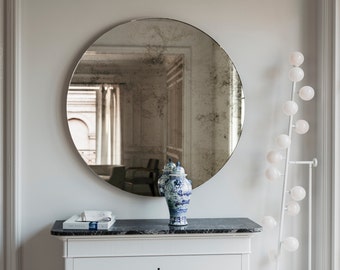 Frameless round hanging wall mirror with antique glass mirror and geometric style. Round antiqued hanging wall mirror.