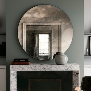 Antiqued round mirror. Decorative wall mirror that casts an interesting, cloudy reflection of room. Round mirror with European chic design. image 4