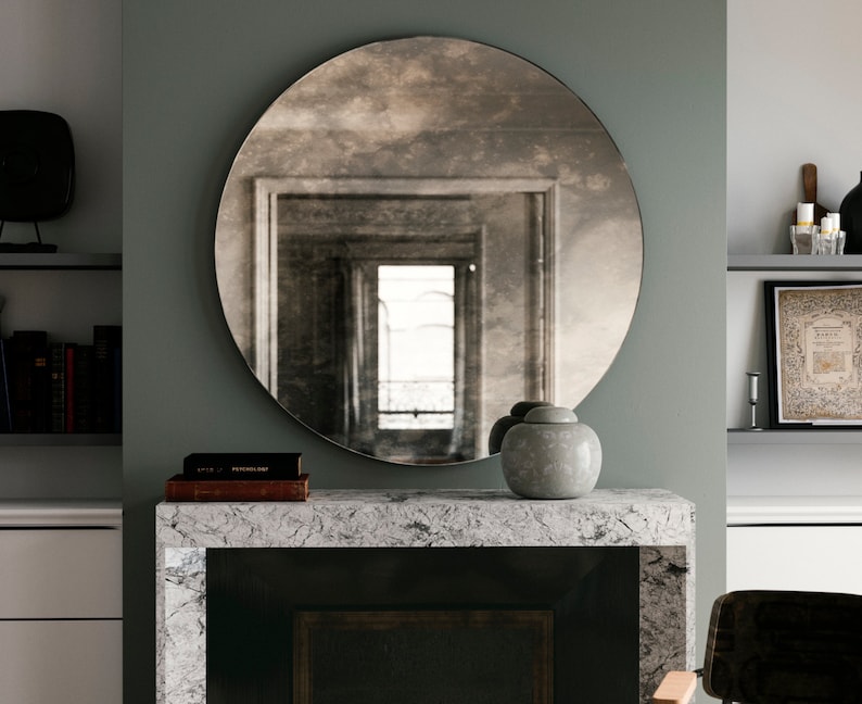 Antiqued round mirror. Decorative wall mirror that casts an interesting, cloudy reflection of room. Round mirror with European chic design. image 4