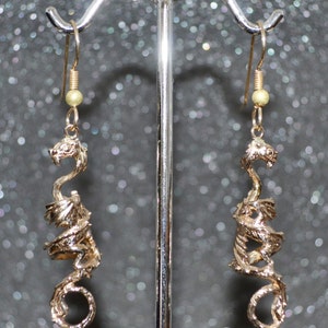 Cast Long Dragon 3D Fantasy Earrings. Bronze and goldfill, coiled pose with curled tail and wings.  Non-plated no nickel and hypoallergenic.