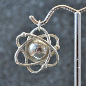 Hollow Cast Dimensional Atom Pendant - Sterling silver stylized subatomic structure models, non-plated, nickel free and hypoallergenic.