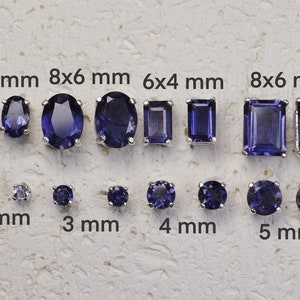 May include: A selection of amethyst gemstones in various shapes and sizes, including oval, square, and round. The gemstones are set in silver and range in size from 2 mm to 8 mm. The image includes text indicating the size of each gemstone in millimeters.
