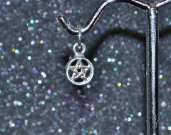 May include: Silver charm with a pentagram design. The charm is hanging from a silver hook.