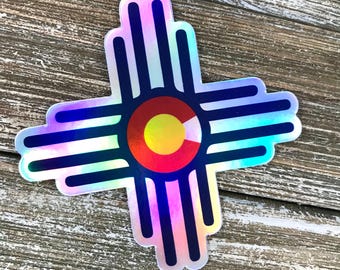 May include: A holographic sticker featuring the symbol of the state of Colorado, a circle with a yellow center and red and white stripes, surrounded by a blue and white iridescent design.