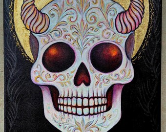 May include: A rectangular canvas painting on a black background featuring a white skull with ornate, colorful filigree patterns, two curved horns, and deep red eye sockets. A large gold circular halo sits behind the skull, and the text "saint & sinner" is written in gold at the bottom.