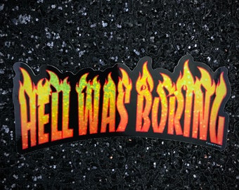May include: A black and yellow sticker with the text "Hell Was Boring" in a flame font.