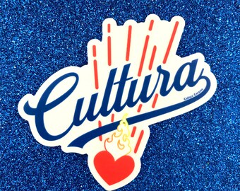 May include: A white sticker with the word "Cultura" in blue cursive lettering with a red heart and yellow flames underneath. The sticker has red and white lines radiating from the heart.