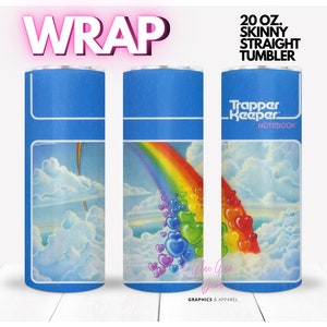 May include: A 20 ounce skinny straight tumbler wrap design featuring a rainbow with hearts floating down from it against a blue sky with white clouds. The text "Trapper Keeper Notebook" is on the tumbler.