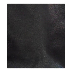 May include: Close-up of a black leather texture with a subtle sheen. The leather has a pebbled surface.
