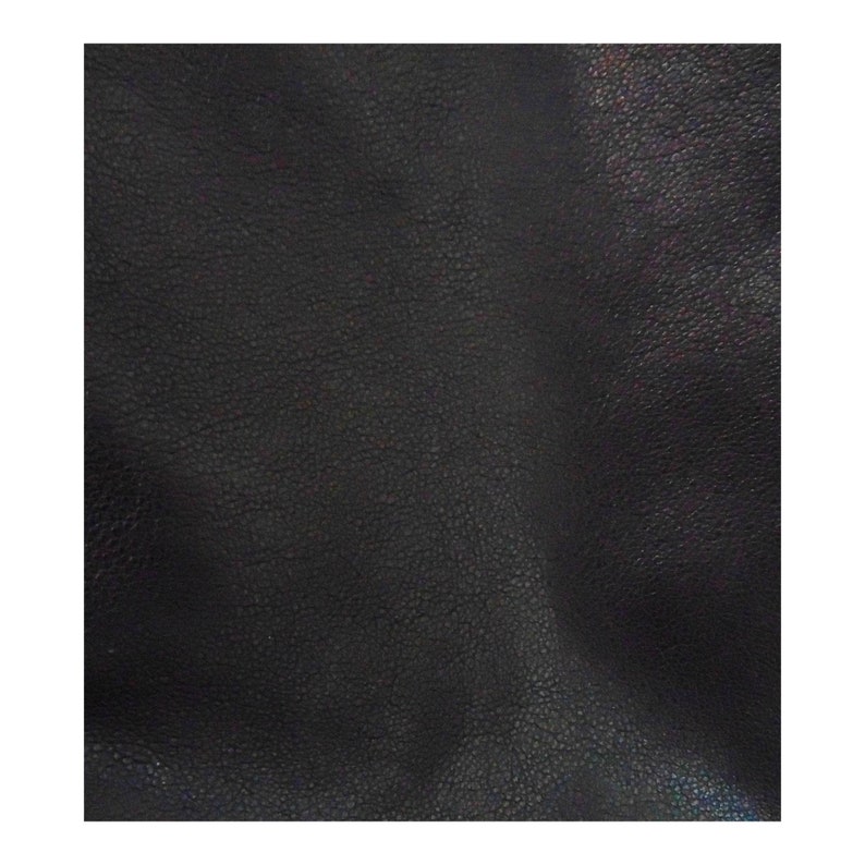 May include: Close-up of a black leather texture with a subtle sheen. The leather has a pebbled surface.