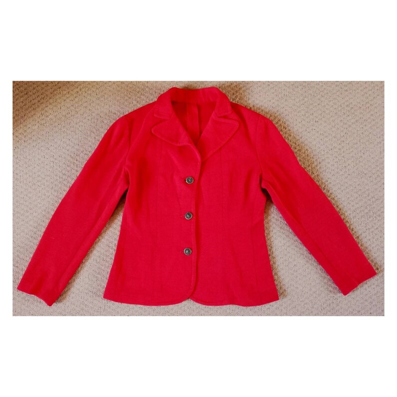 May include: A red blazer with a notched collar and four buttons down the front.
