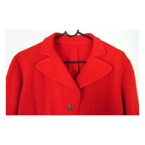 May include: A red blazer with a single button fastening and a pointed collar.