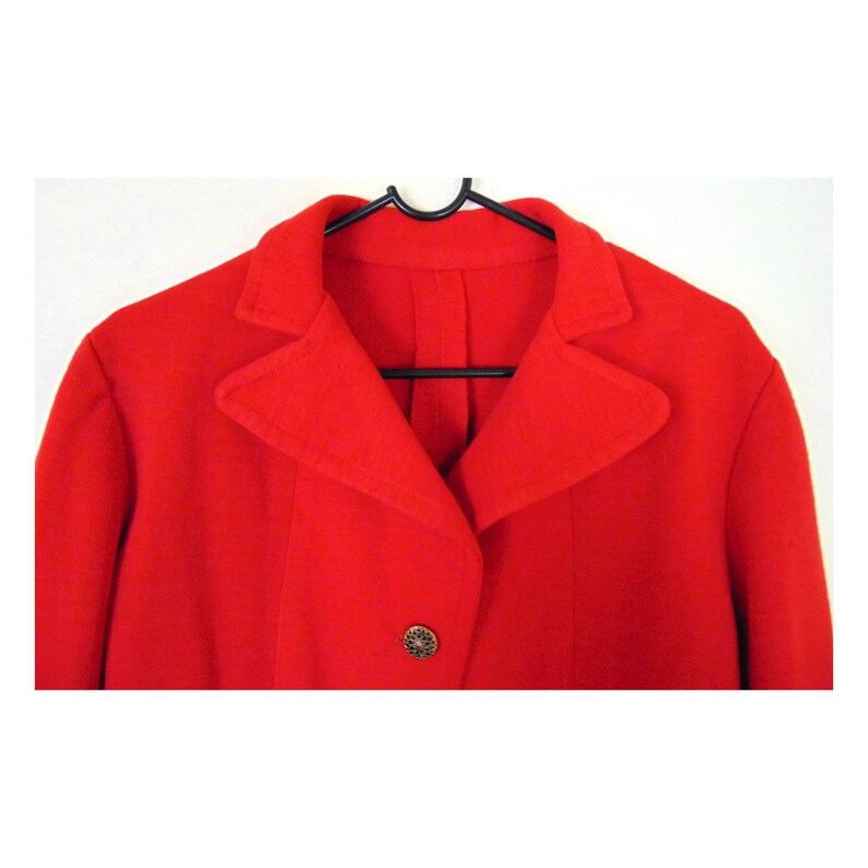 May include: A red blazer with a single button fastening and a pointed collar.