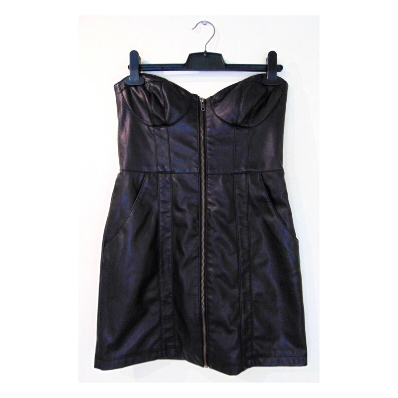 May include: A black strapless dress made of faux leather with a zipper down the front. The dress has a fitted bodice and a slightly flared skirt.