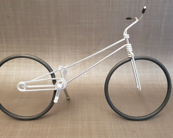 Miniature trial bike in aluminum wire. Trial bike in aluminium wire