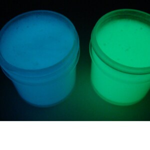 May include: Two small containers of glow-in-the-dark paint. One container is blue and the other is green.