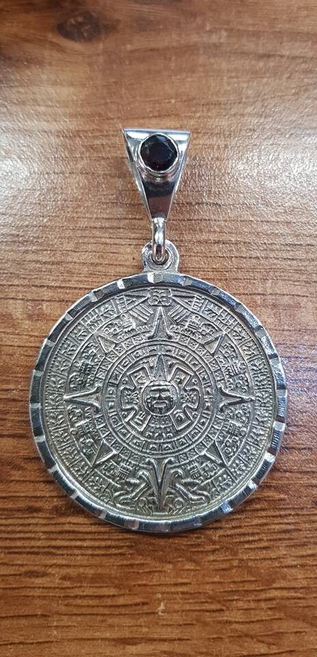 Silver aztec shop calendar pendant