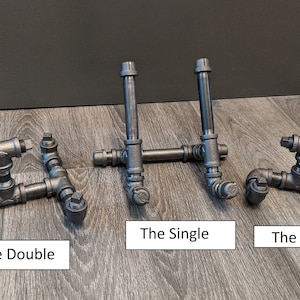 May include: Three different sizes of black metal pipe stands, labeled "The Double", "The Single", and "The Mini".