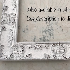 May include: White ornate picture frame with a decorative, raised design. The frame is made of wood and has a distressed finish. Also available in white! See description for link.
