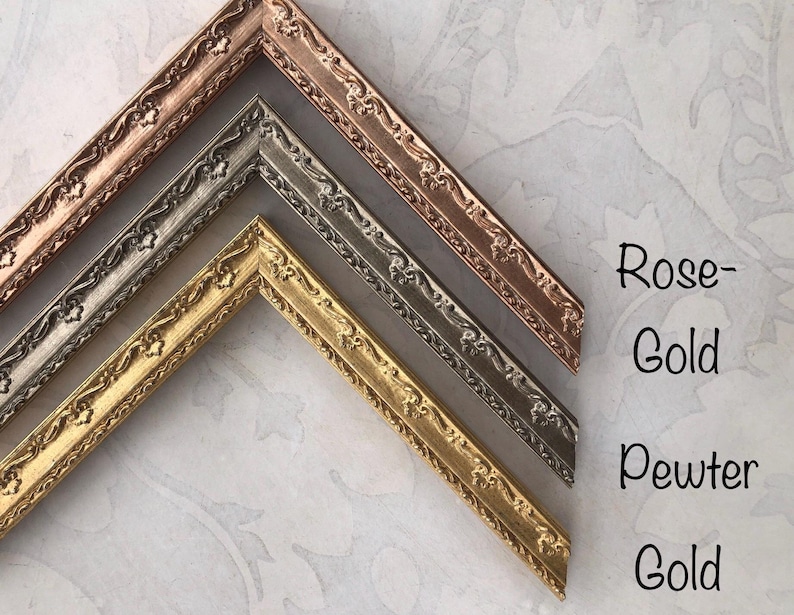 May include: Close-up of decorative picture frame corners in rose gold, pewter, and gold. The frames have ornate floral detailing. Text on the right reads "Rose-Gold", "Pewter", and "Gold".