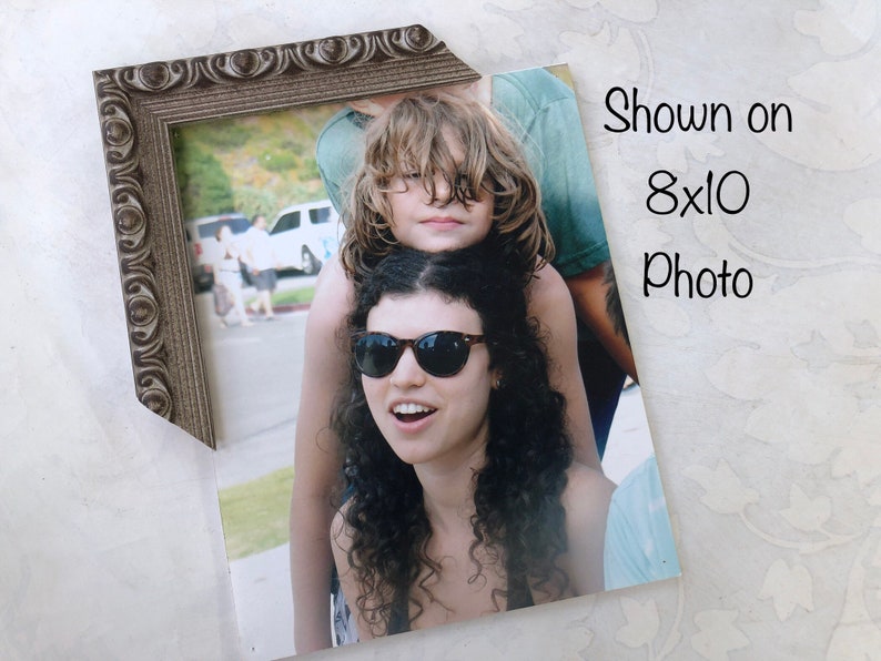 May include: A brown ornate picture frame with a photo of two people. The photo shows a woman with long curly hair wearing sunglasses and a man with long blonde hair. The text "Shown on 8x10 Photo" is printed on the photo.