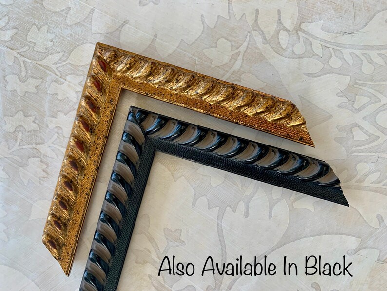 May include: Two picture frames, one gold and one black, with a rope-like design. The text "Also Available In Black" is visible below the frames.