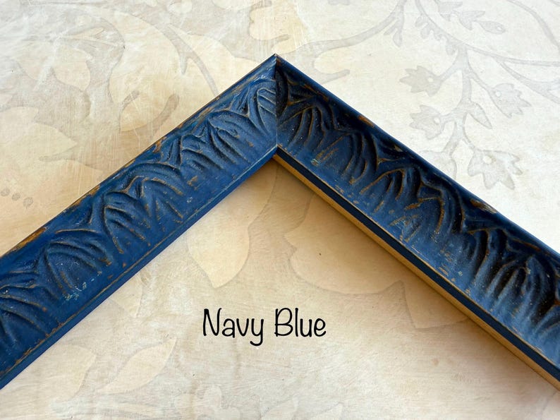 May include: Navy blue picture frame corner with carved leaf design. The frame has a distressed finish, with hints of gold peeking through the navy paint. The text "Navy Blue" is written in a script font.